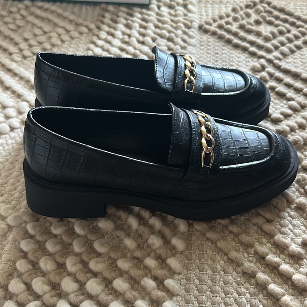 Chunky black loafers with gold details